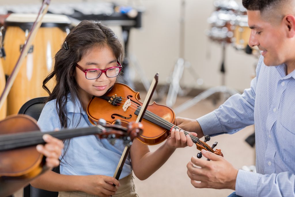 What instrument should my child take lessons on? Young girl taking violin lessons